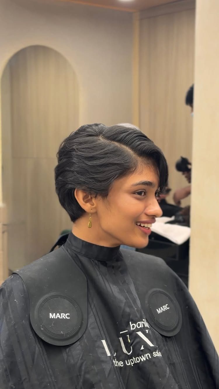Short dark pixie cut styled neatly at a salon