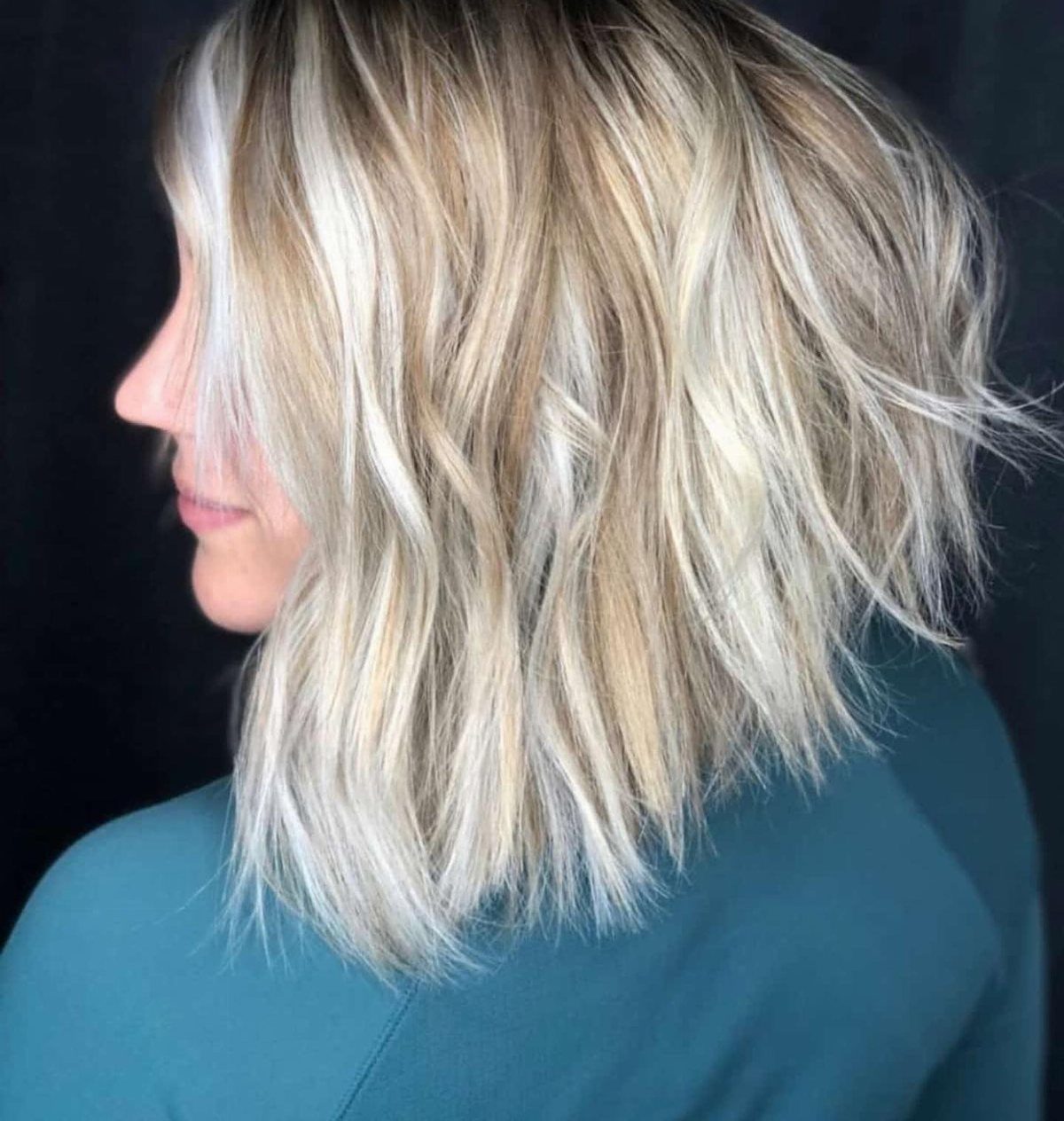 Blonde woman with a choppy angled bob, longer in front and shorter behind