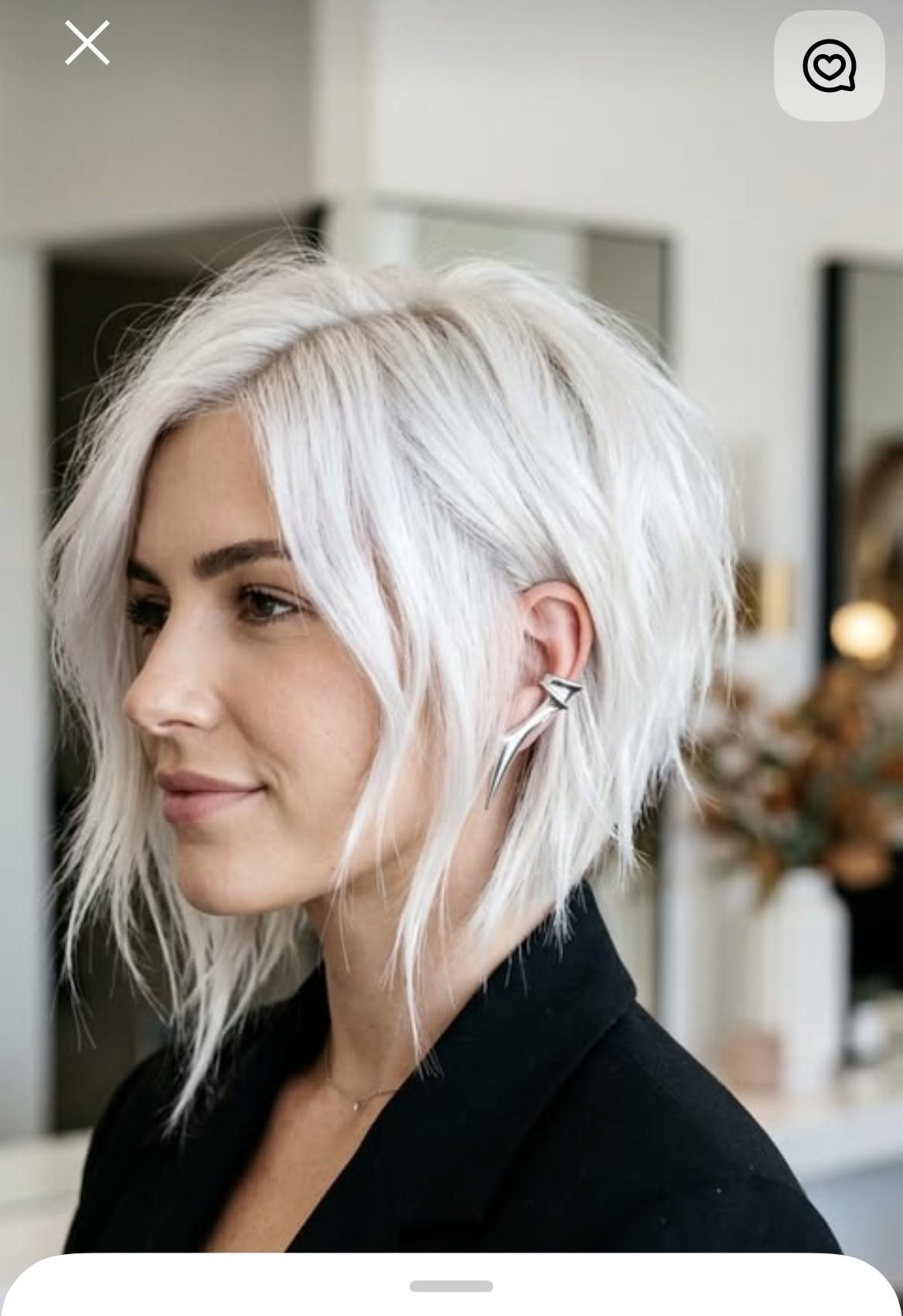 Silver angled bob with longer front pieces and a tapered back on a woman
