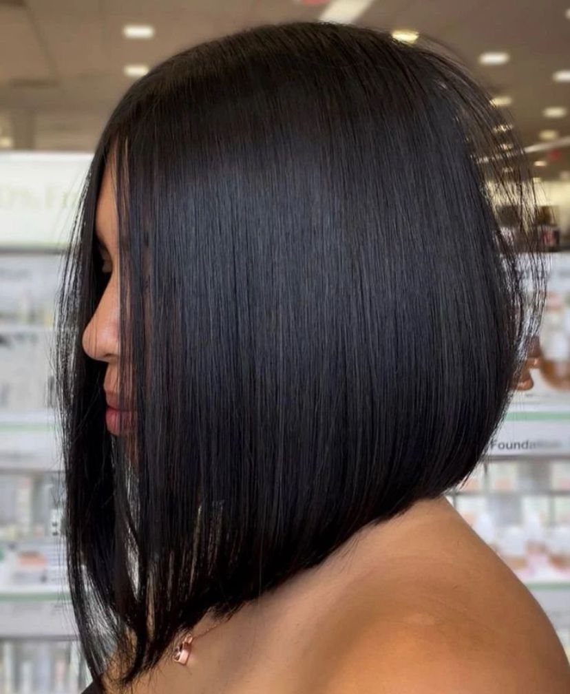 Sleek black bob with long face-framing sections and a shorter back