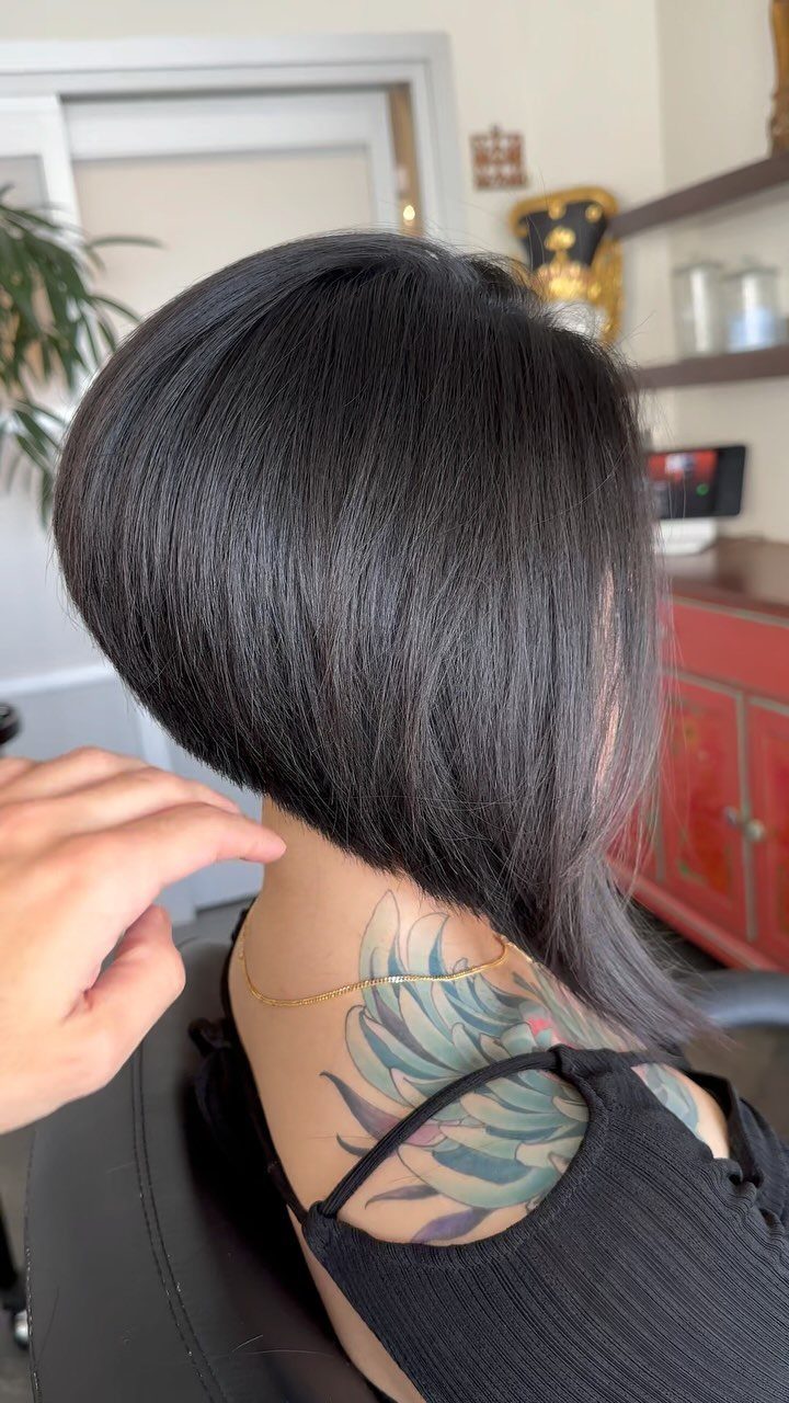 Black stacked bob with a rounded short back and longer front sections