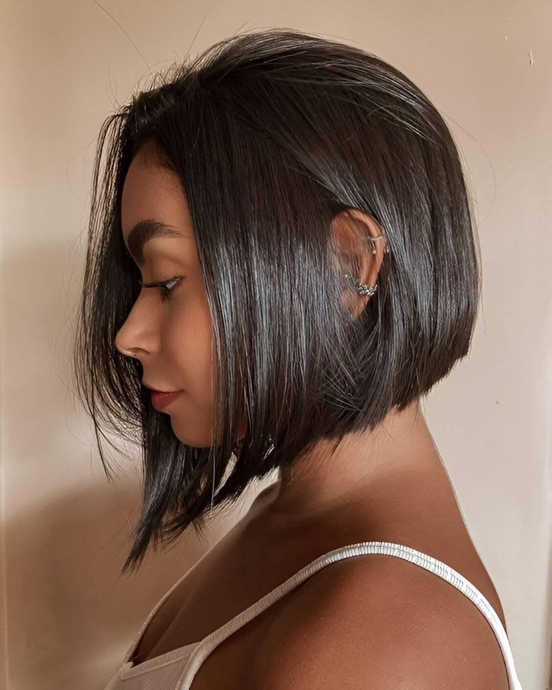 Woman with sleek straight layered bob, longer front and shorter rounded back