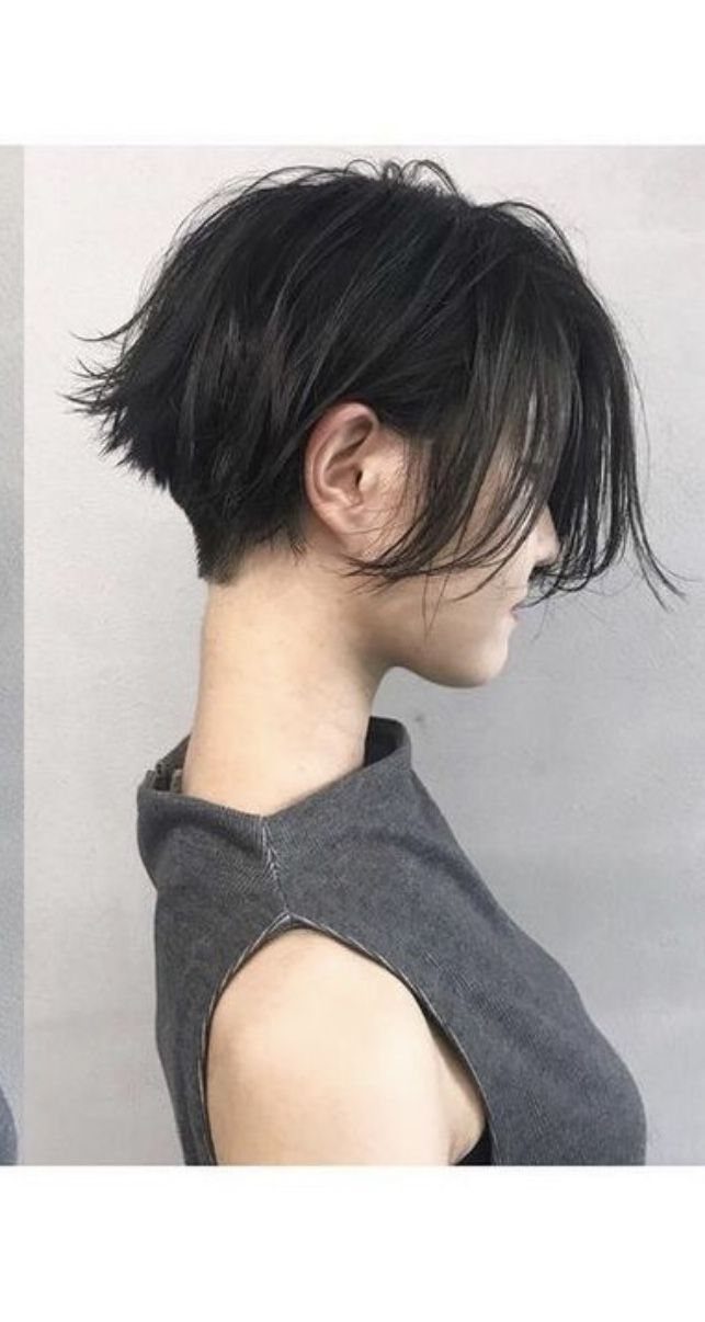 Short black haircut with a long fringe swept across the forehead