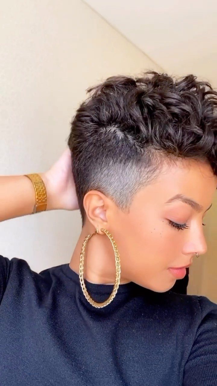 Short curly haircut with voluminous curls on top and closely cropped sides