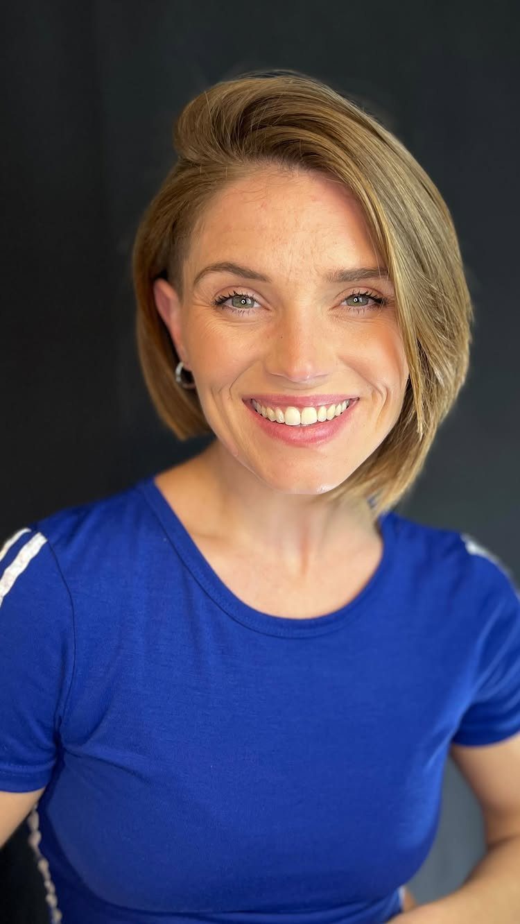 Woman with a side-parted blonde bob cut longer on one side