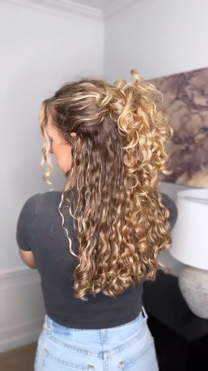 Half-up curly bun with long loose curls hanging down