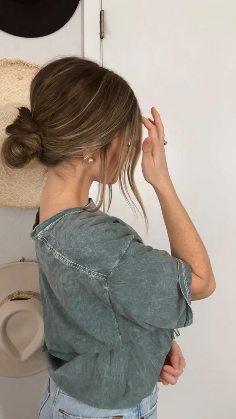 Woman showing a low messy bun with loose face-framing strands