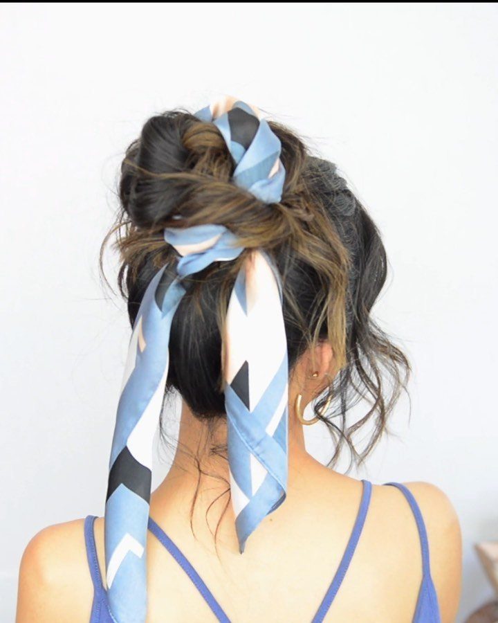 Tousled brown bun wrapped with a long blue and white patterned scarf