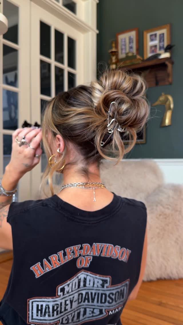 Tousled textured bun secured with a silver claw clip, viewed from behind