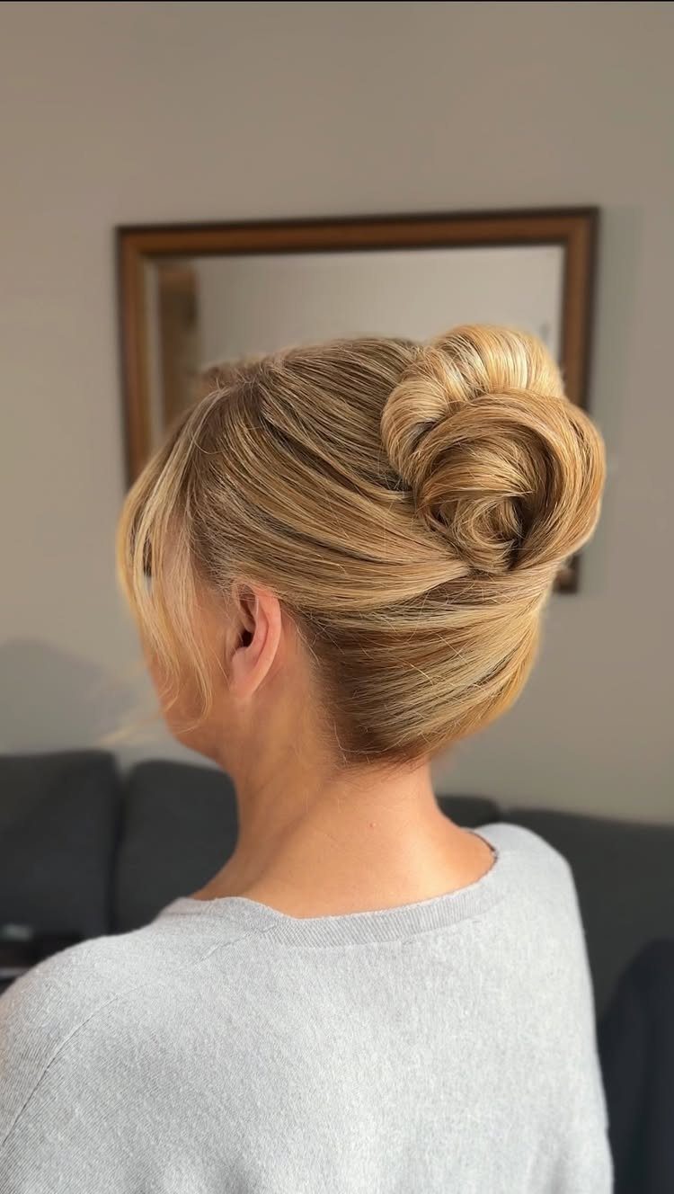 Blonde woman wears a voluminous low bun with soft crown lift