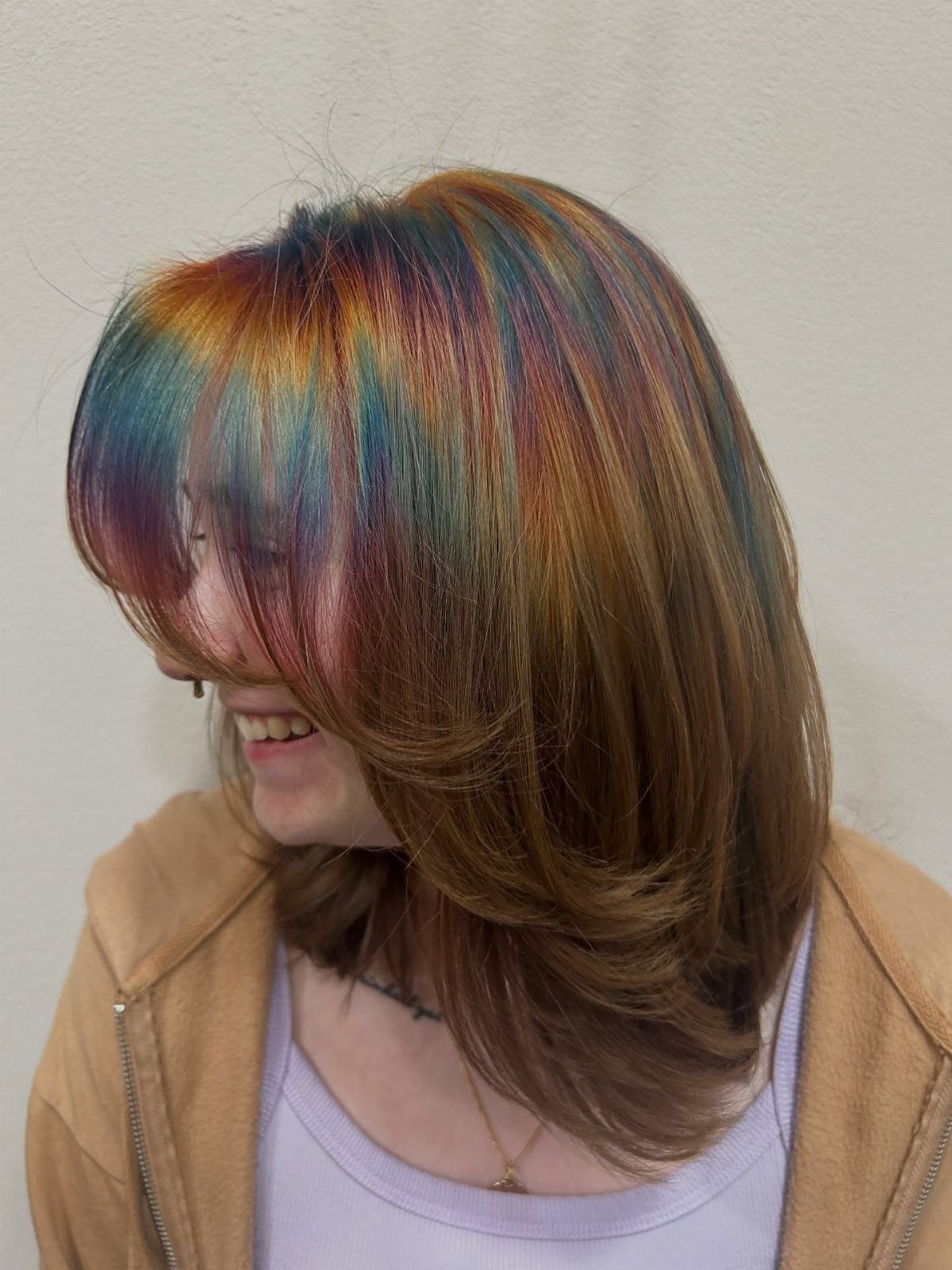 Layered brown hair with blended teal, purple, magenta, and copper streaks