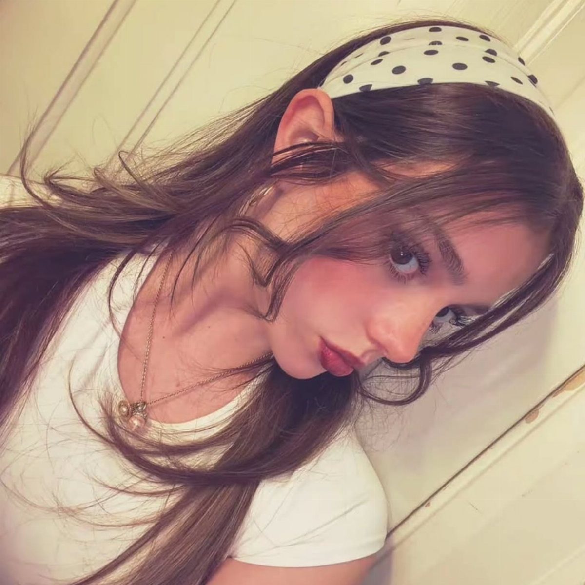 Young woman wearing a polka dot headband with long hair left down