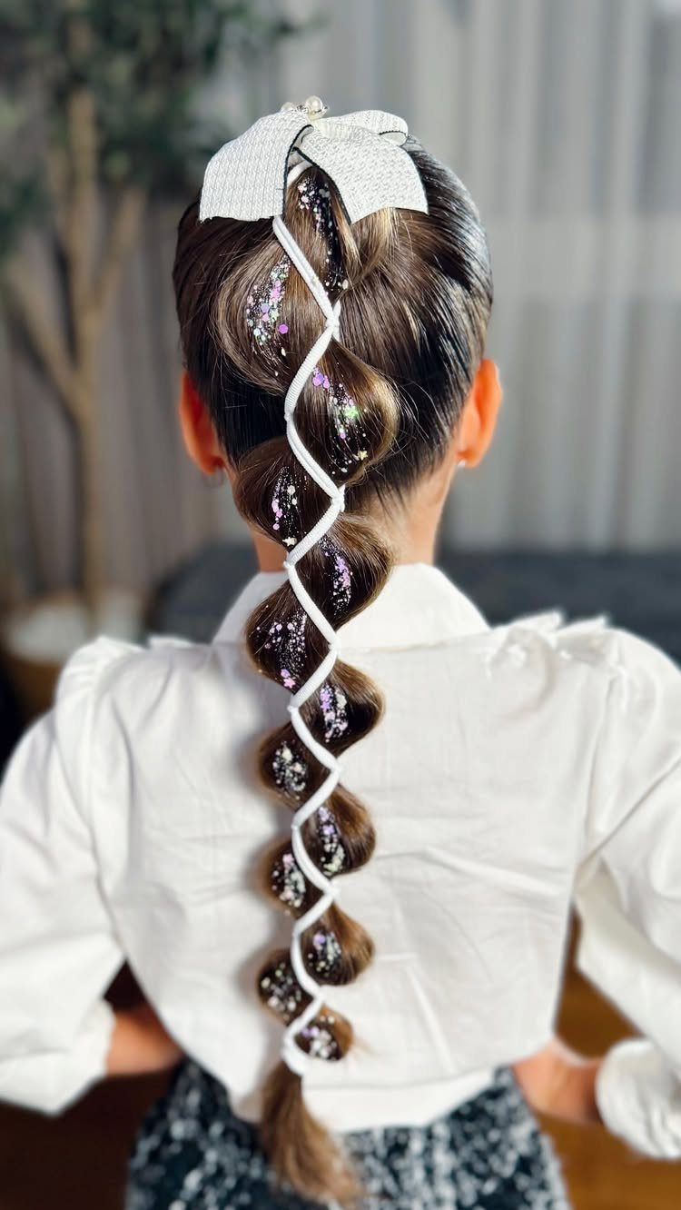 Back view of a person with a ribbon-woven braid and oversized bow