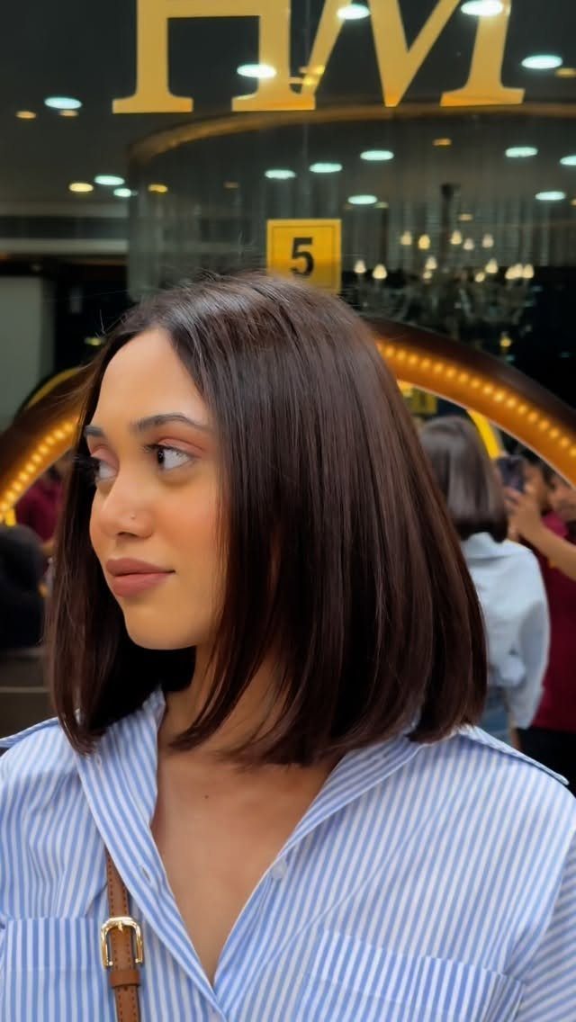 Woman showing a sleek, shoulder-length blunt bob with a straight edge