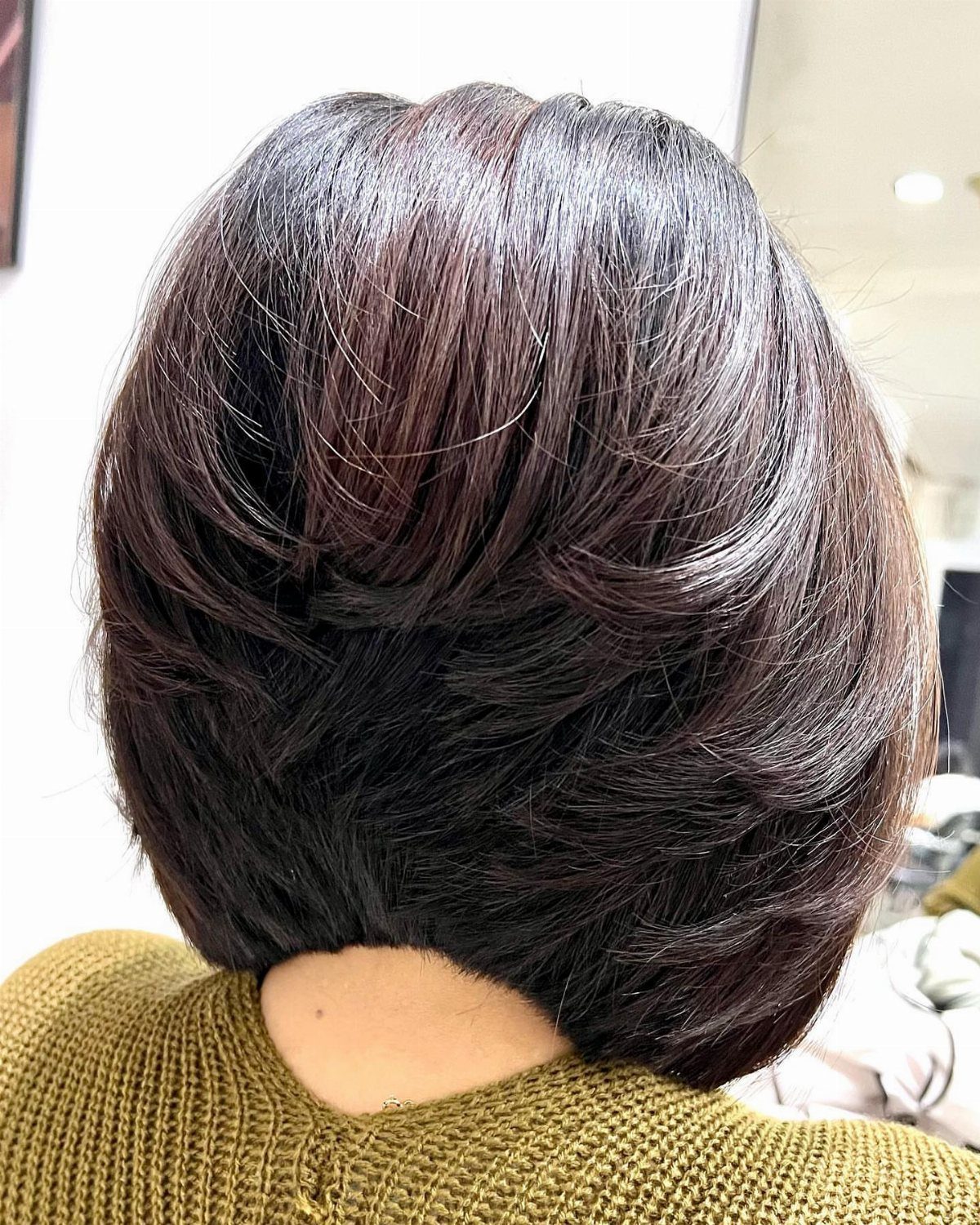 Dark brown graduated bob, layered short at the nape and longer at the sides