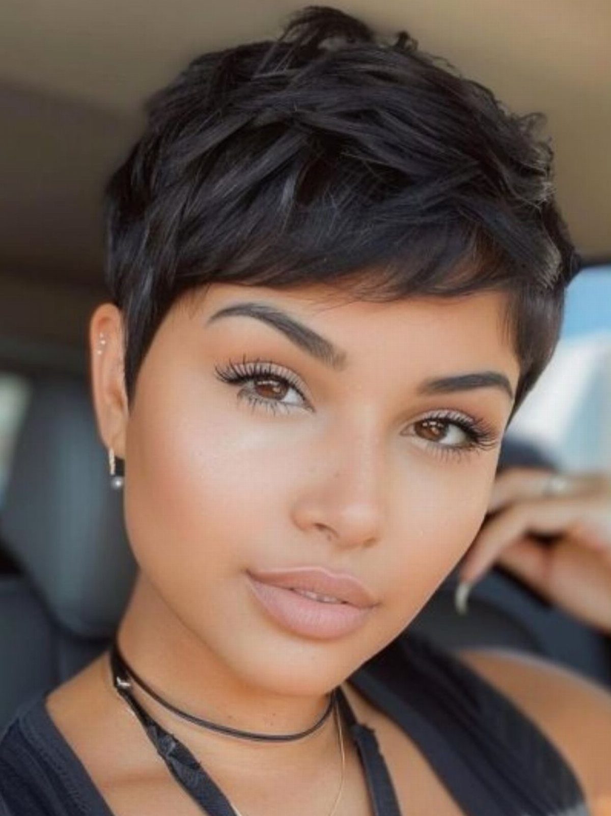 Short dark pixie cut with textured layers and side-swept fringe