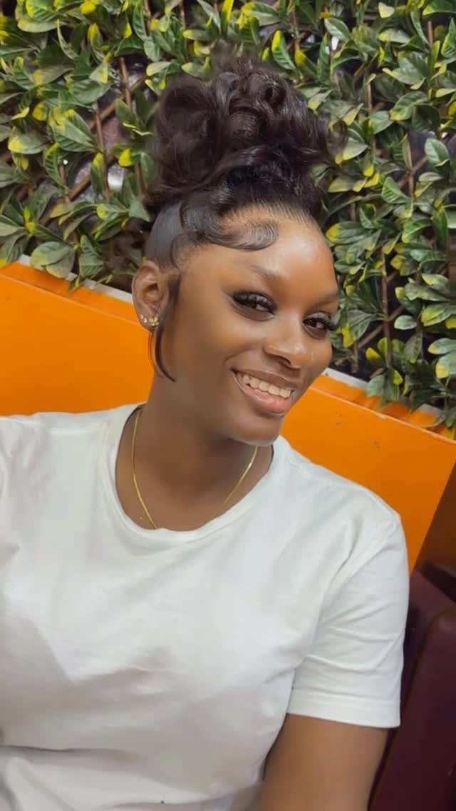 Woman wearing a voluminous pompadour updo with styled edges