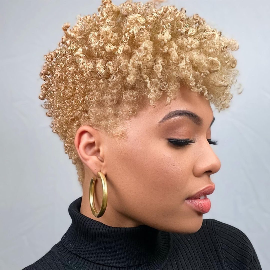Short blonde curls in a close crop, fuller on top with closely trimmed sides