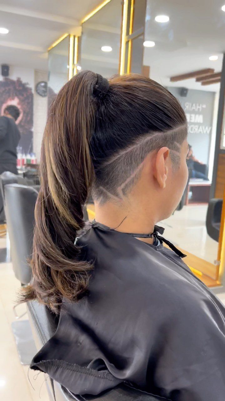 Ponytail with a geometric zigzag design shaved above the ear