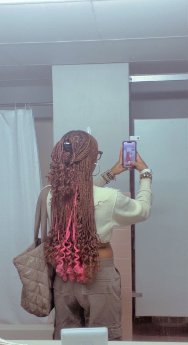 Braided reddish-brown hair with vivid hot-pink underlayers visible near the ends