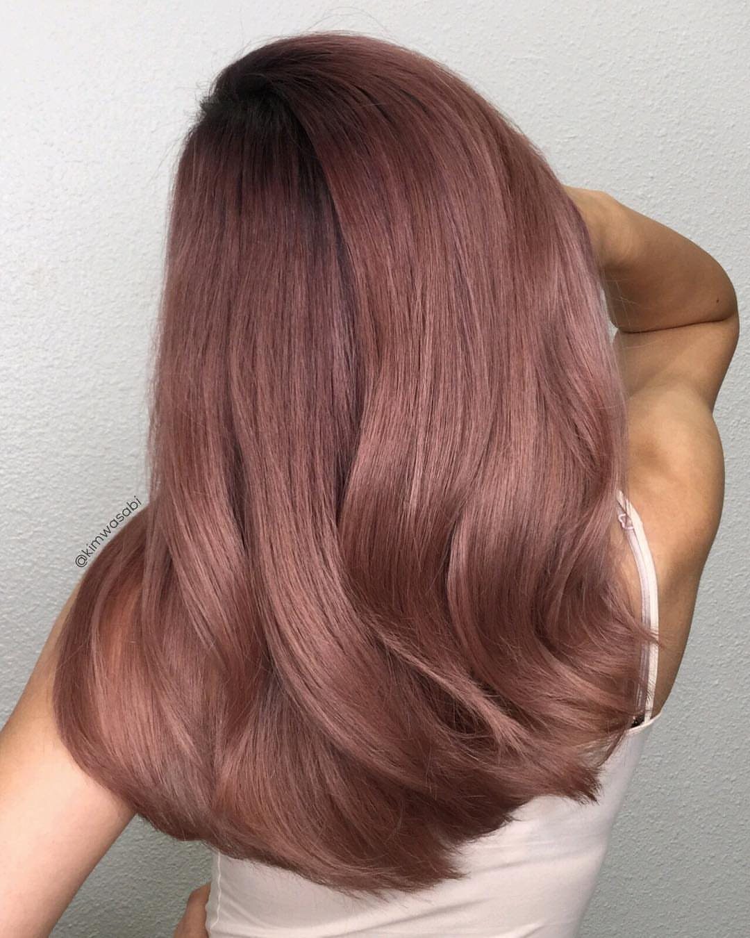 Dusty rose shoulder-length hair with darker roots and softly curled-under ends