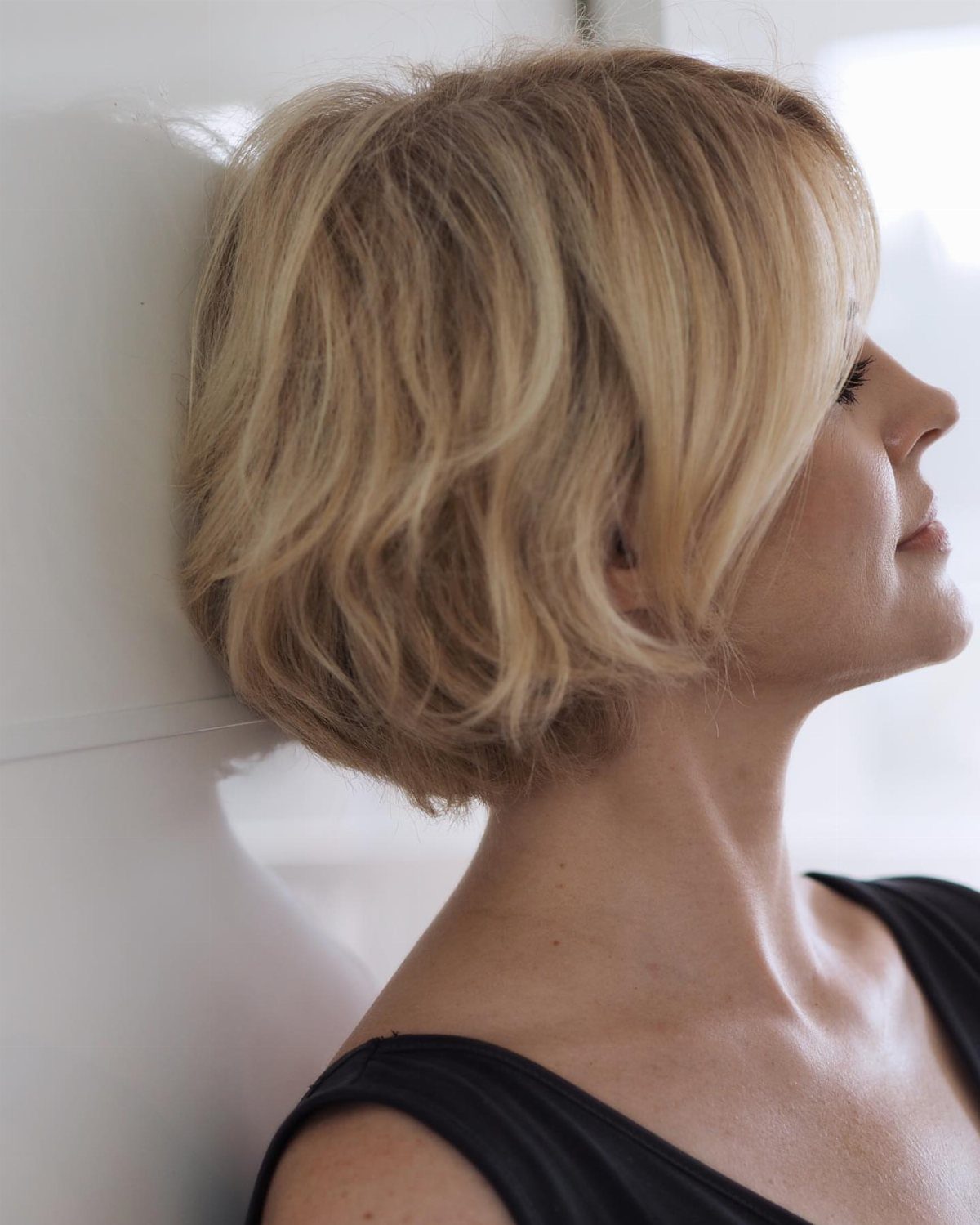 Blonde woman with a full, airy choppy bob and layered waves