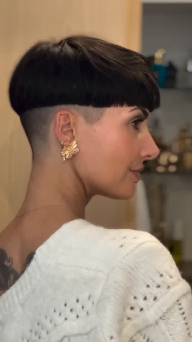 Bowl-shaped pixie with blunt fringe and shaved sides in profile