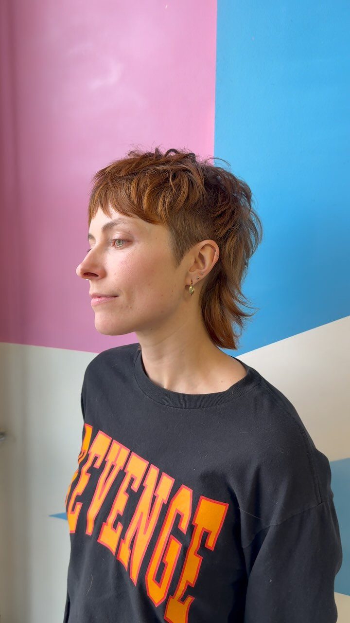 Short choppy brown mullet with cropped sides and longer back layers