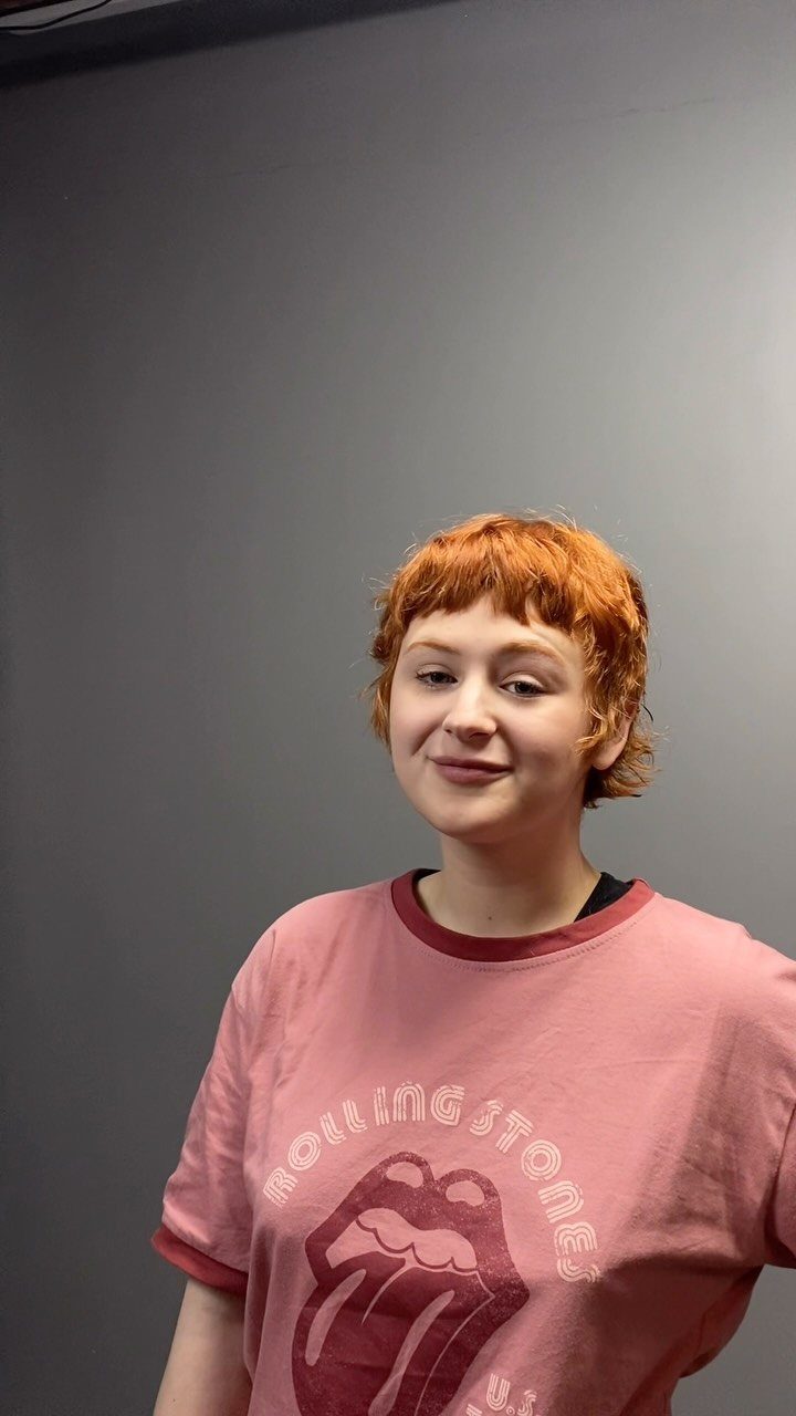 Copper-red pixie cut with tousled layers and short fringe