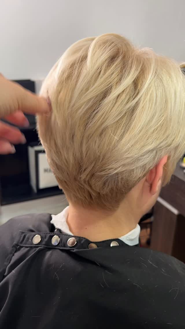 Short textured blonde pixie with choppy layers and a tapered nape