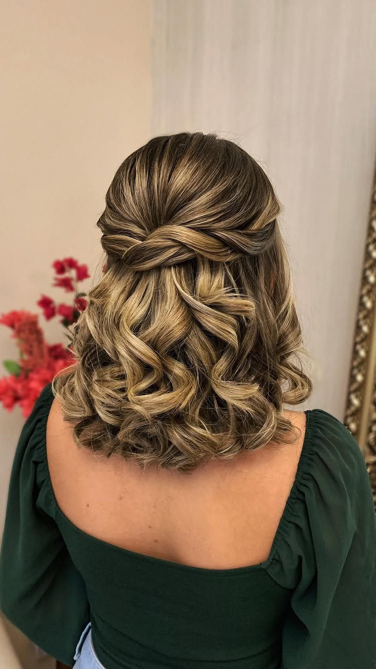 Twisted half-updo with curled ends styled on short blonde and brown hair