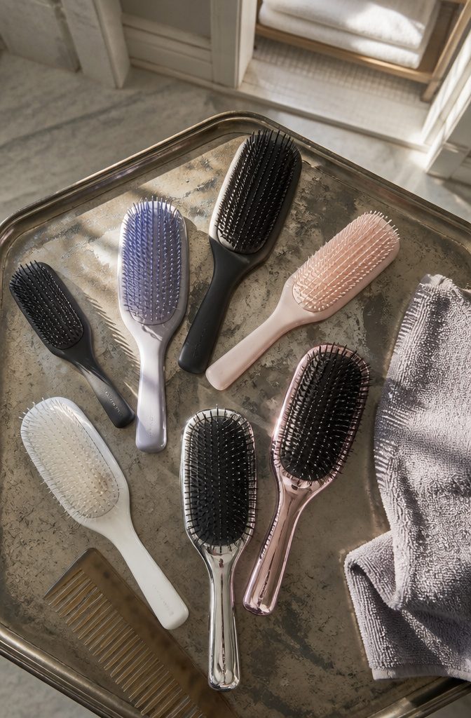 Ultimate Detangler brush shown with a selection of product versions