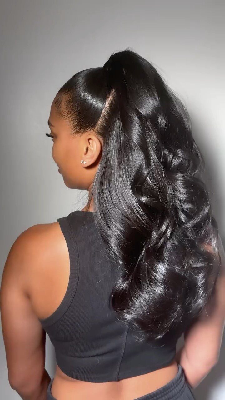 Woman showing a sleek high ponytail with glossy, softly curled ends