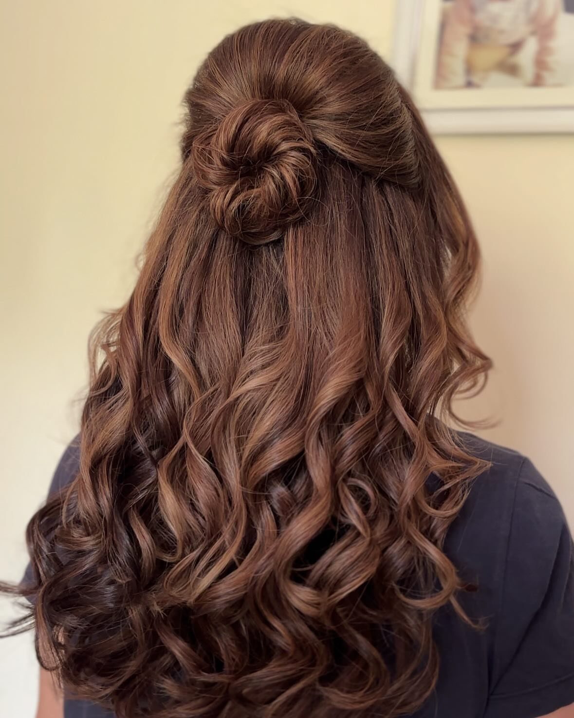 Half-up top knot with long brown curls left loose down the back