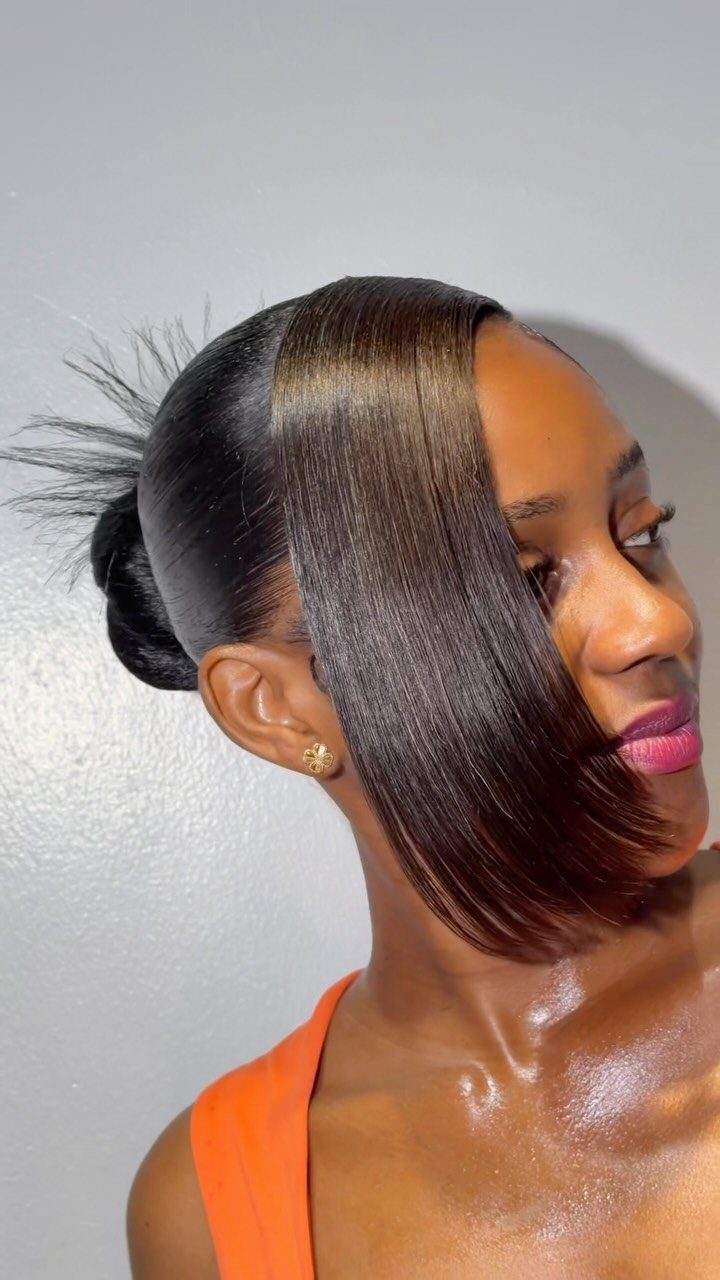 Woman wearing a sleek updo with a long side-swept section over her face